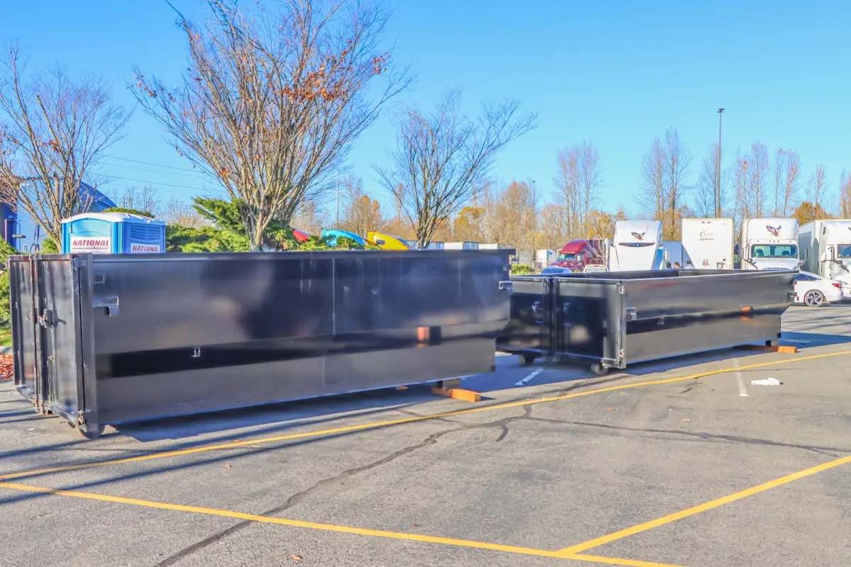 Professional dumpster rental service with roll-off container on residential driveway in Valparaiso